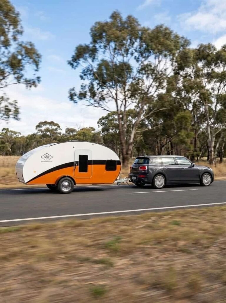 Orange JAG Teardrop Camper being towed by a Mini on an Australian road